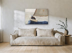 Single Sail Heeling coastal canvas print on the wall of a living room
