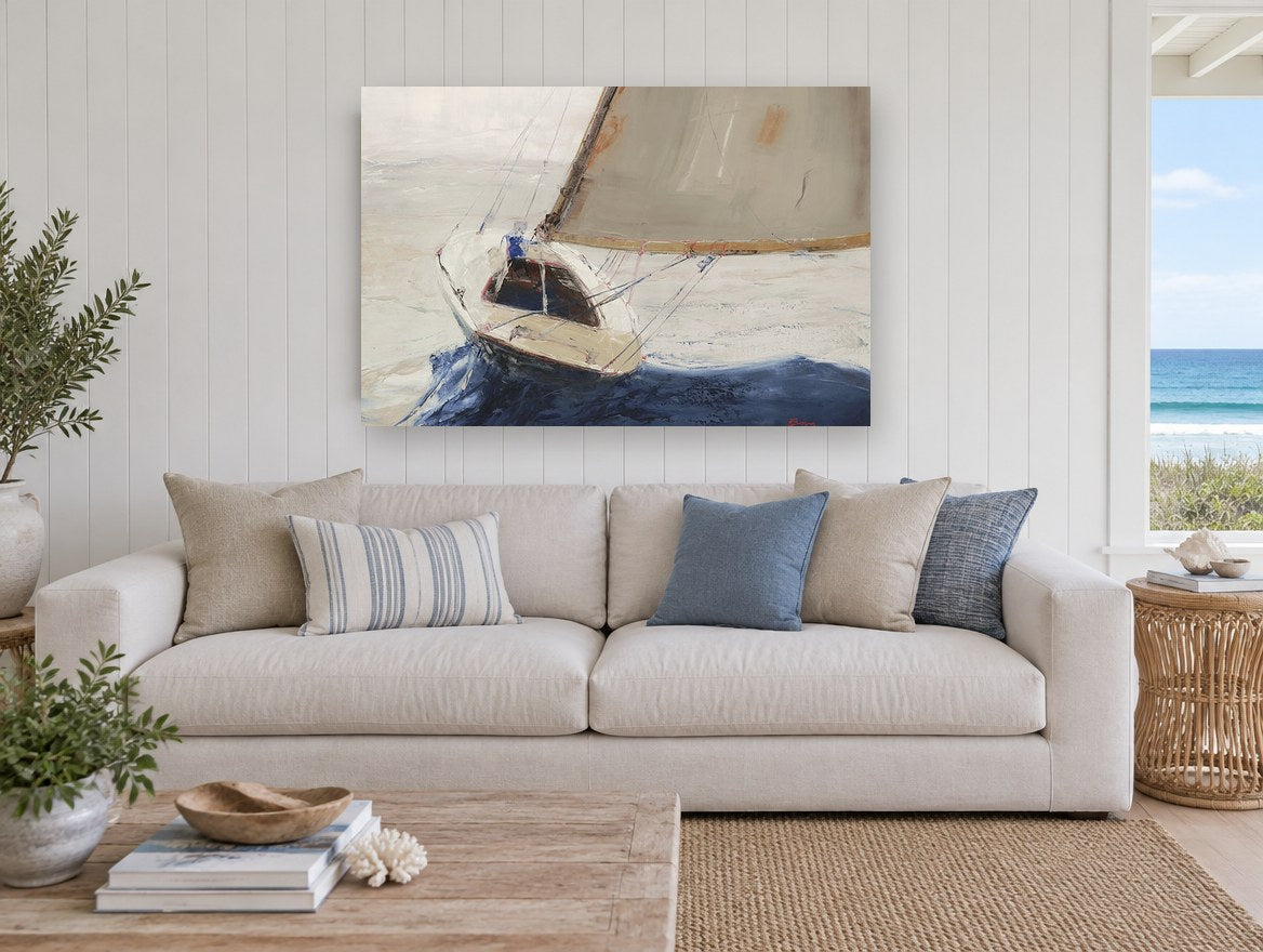 Single Sail Heeling coastal canvas print on the wall of a beach house living room