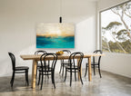 Golden Shore Teal Haze coastal canvas print on the wall of a dining room