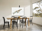 Gliding Seal Splash coastal canvas print on the wall of a dining room