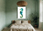 Teal Ink Seahorse coastal canvas print on the wall of a bedroom