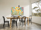 Sunlit Meadow Blooms floral canvas print on the wall of a dining room