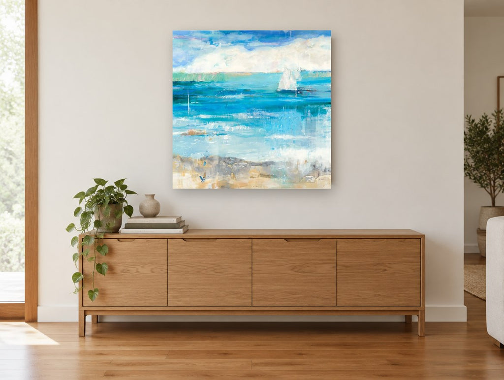 Sail Beyond the Shallows coastal canvas print on the wall of a living room above a sideboard