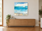 Sail Beyond the Shallows coastal canvas print on the wall of a living room above a sideboard