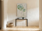 Silver Monstera Pair floral canvas print on the wall of a hallway