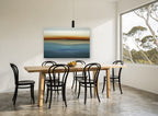 Blue Horizon Haze coastal canvas print on the wall of a dining room