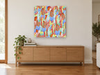 Rainbow Feather Tumble animal canvas print on the wall of a living room above a sideboard