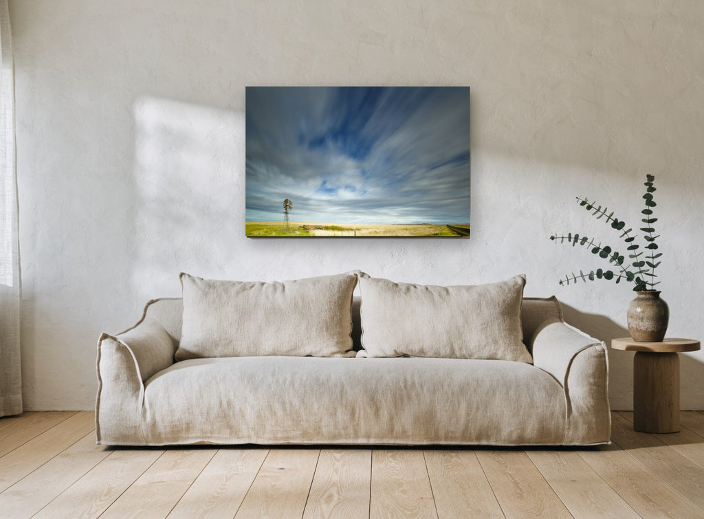 Windmill Under Streaking Sky landscape canvas print on the wall of a living room