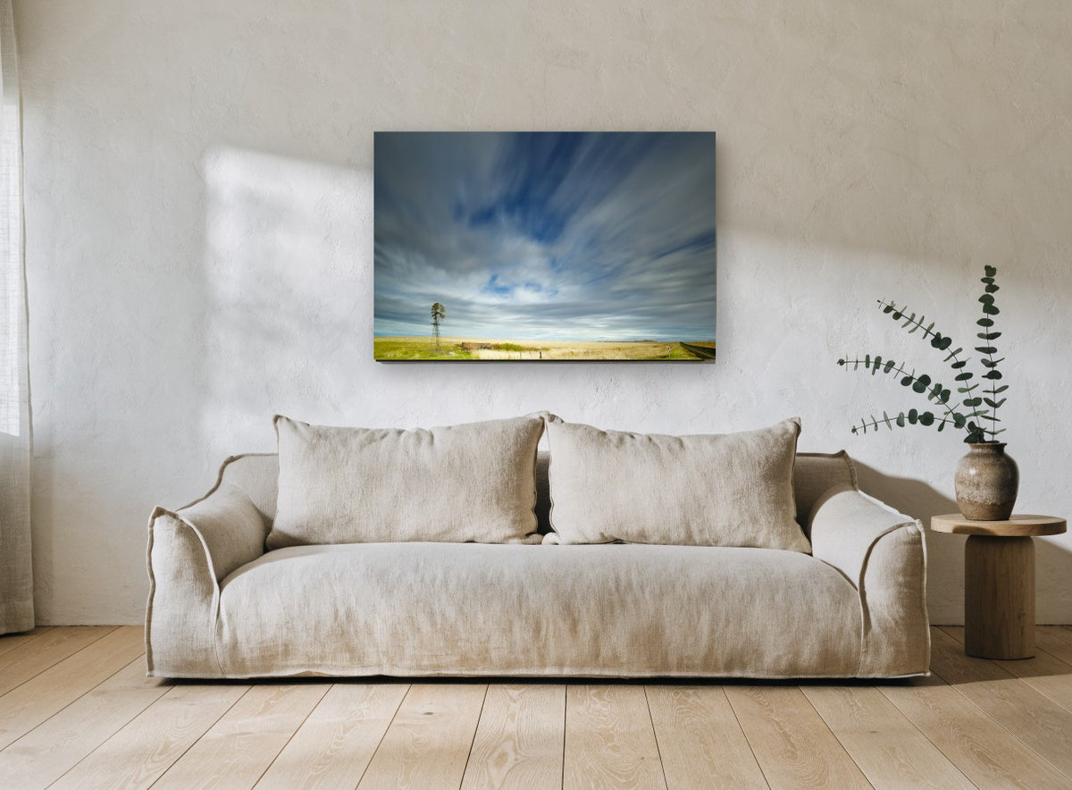 Windmill Under Streaking Sky landscape canvas print on the wall of a living room