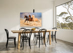 Three Horses Galloping landscape canvas print on the wall of a dining room