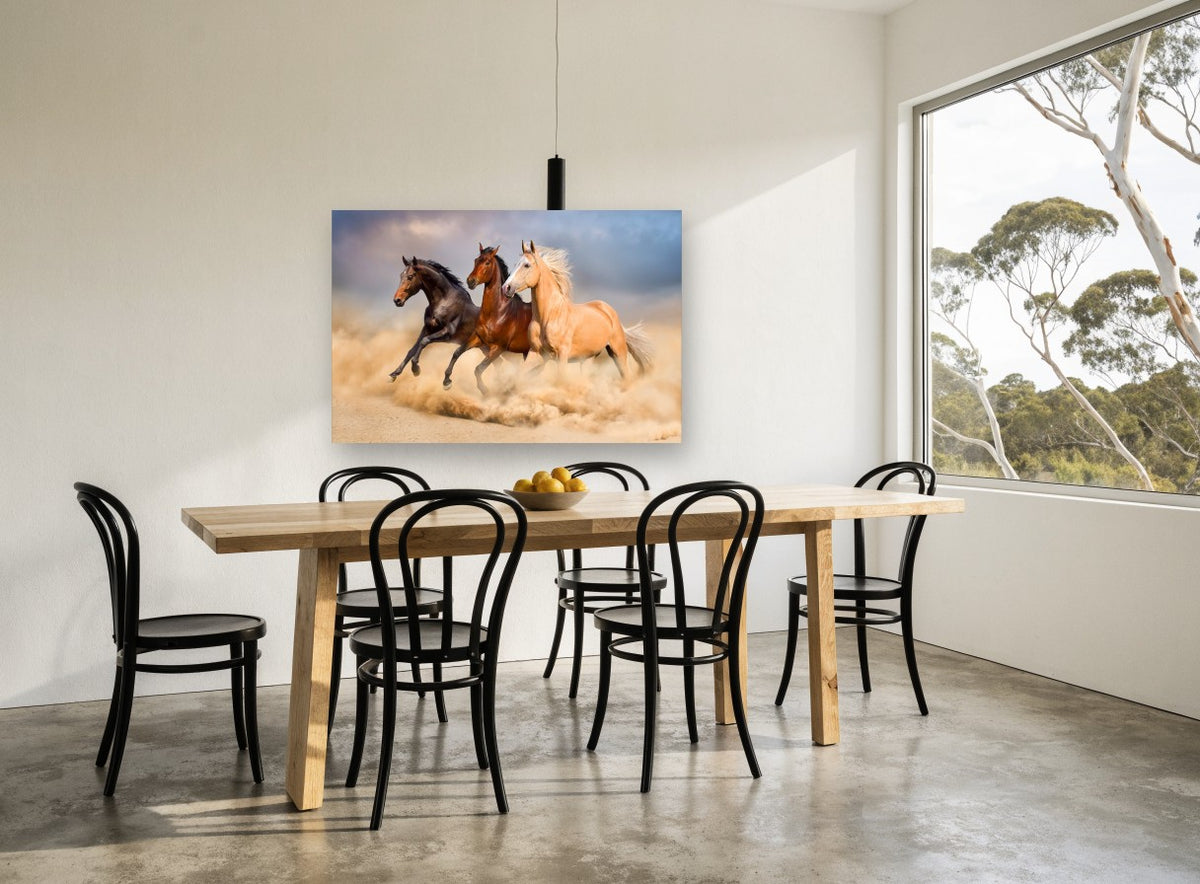Three Horses Galloping landscape canvas print on the wall of a dining room