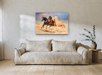 Three Horses Galloping landscape canvas print on the wall of a living room