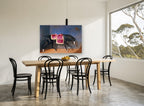Saddled Black Stallion animal canvas print on the wall of a dining room
