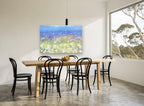 Dandelion Meadow Haze floral canvas print on the wall of a dining room