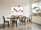Gerbera Row floral canvas print on the wall of a dining room